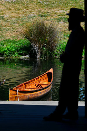 CHRISTCHURCH - DEC 04 2015:Silhouette of a Punting sailor on the Avon river Christchurch.It is an iconic tourist attraction of Christchurch, New Zealand.のeditorial素材