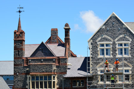 CHRISTCHURCH - DEC 07 2015:Builders fix a damaged historical building in Christ's College Christchurch.Over 1000 buildings in the Central Business District were demolished following the earthquakes.のeditorial素材