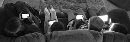 AUCKLAND -  JAN 14 2016:Teenagers play on electronic devices.New study suggests that spending too much time using electronic devices during the day harms teens sleep at night.のeditorial素材