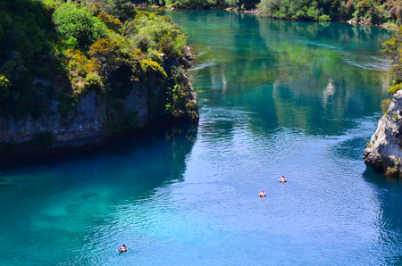 TAUPO, NZL - JAN 14 2016:Aerial view of people floating on tubes over the Waikato River near Taupo.It's the longest river in New Zealand, running for 425 kilometres (264 mi) through the North Island.のeditorial素材