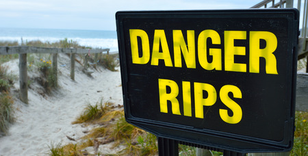 Danger rips of strong currents sign posted on the beach. copy space concept conceptual.の写真素材