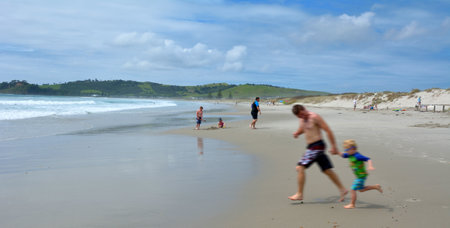 OMAHA, NZL - JAN 26 2016: Visitors in Omaha beach, New Zealand.It's a very popular tourist destination in Auckland Region, New Zealandのeditorial素材