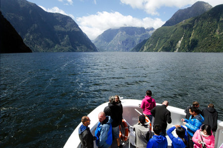 MILFORD SOUND,NZ - JAN 14:Visitors sail in Milford Sound on Jan 14 2014.It has been judged the world's top travel destination in the 2008 Travelers Choice Destinations Awards by TripAdvisor.のeditorial素材