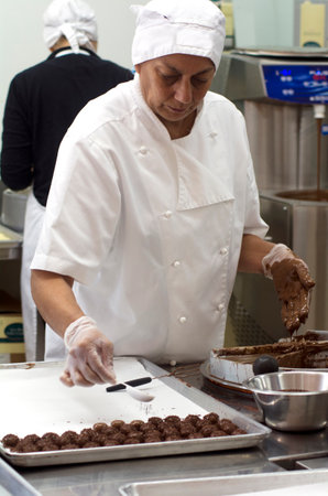 KERIKERI, NZ - JAN 07: Chocolate factory worker prepares dipped Chocolate balls on Jan 07 2014.Almost half the world's chocolate is consumed in America.のeditorial素材