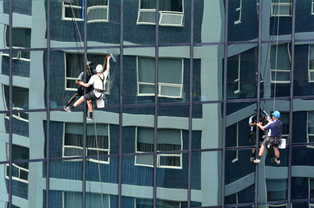 AUCKLAND - MAR 02 2016:Window cleaners works on high rise building.Window cleaning is considered one of the most dangerous job in the world.Several window cleaners die each year and many are injuredのeditorial素材