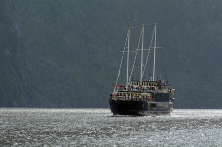 MILFORD SOUND,NZ - JAN 14:Visitors sail in Milford Sound on a cruise boat on Jan 14 2014.It's New Zealand's most famous tourist destination.のeditorial素材