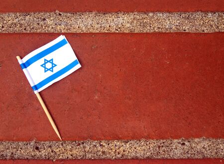 Flat lay of the flag of Israel on a brick surface. Israel indepandace Day background withe copyspaceの写真素材