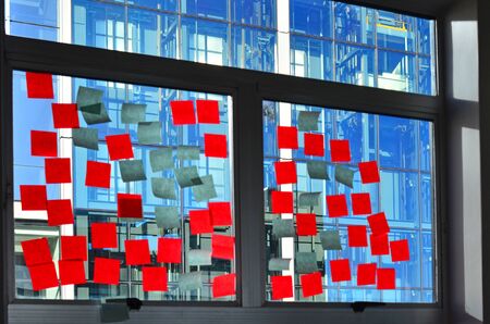 notes on office building window after brainstorming meeting.Horizontal