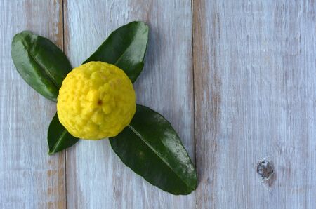 Flat lay of Kaffir lime on a wooden table.Food background and texture with copy spaceの写真素材