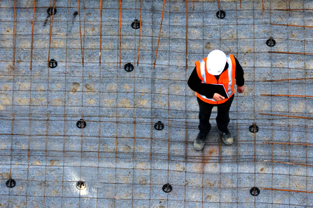 Aerial view of unrecognised civil engineers inspecting the work progress in a construction site....