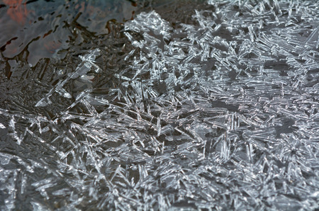 Ice edge of ice water crystals on river bank.