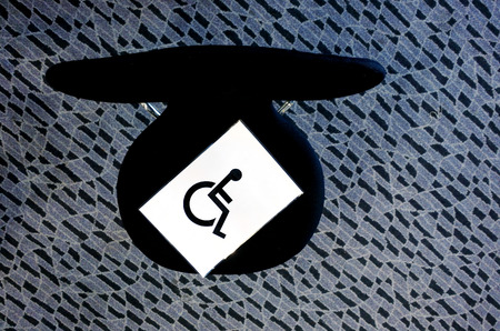 Flat lay view of a seat preserved to a disabled person with International Symbol of Access on it. Disability concept. copy spaceの写真素材