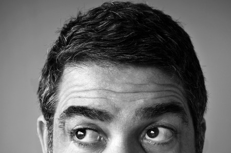 Close up of eyes of a man (age 40-45) looking for something. Man middle age concept. copy spaceの写真素材