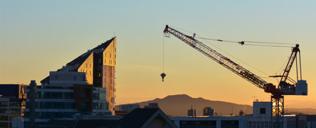 AUCKLAND - AUG 16 2016:Tower crane against Auckland skyline. A record number of over 50 cranes operating in the city building apartment blocks, office towers and other major urban public projects.のeditorial素材