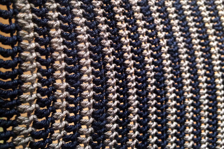 Hand woven patterned fabric. Abstract background and texture.