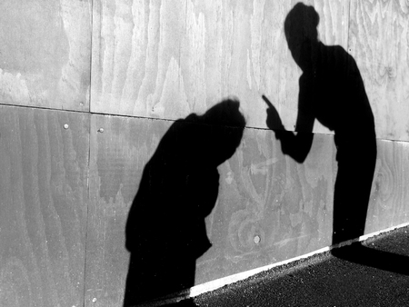 Shadow on a wall of mother child conflict: mother scolds her child (girl age 6) outdoor. Family, parenthood, childhood and children lifestyle concept . copy space (BW)の写真素材