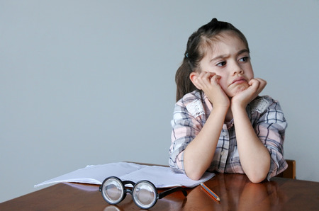 Upset child (girl age 6 -7) do not want to do homework. Children childhood education conceptの写真素材