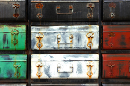 Many old colourful vintage metal suitcases Abstract background and textureの写真素材