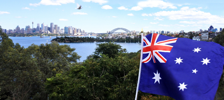 The National flag of Australia flies along Sydney skyline, Australiaの写真素材