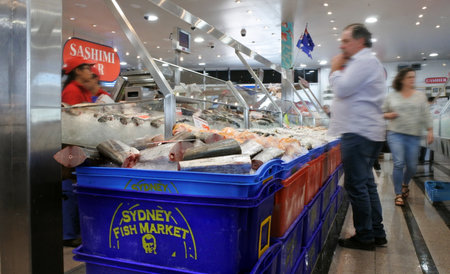 Sydney, Australia - OCT 20 2016:Vendor sells seafood in Sydney Fish Market, a Large marketplace  and a major tourist attraction featuring shops for seafood, deli items and restaurants.のeditorial素材