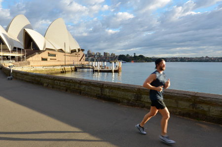 SYDNEY - OCT 19 2016:Australian man runs near the Opera House in Sydney, Australia. Approximately 35% of the Australian population participated at least in one physical recreation activity.のeditorial素材