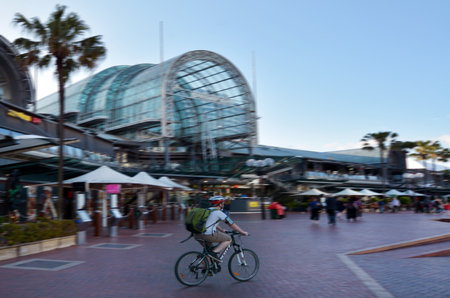 Sydney, Australia - OCT 20 2016: Man ride a bike in Darling Harbour, a recreational and pedestrian precinct situated on western outskirts of the Sydney central business district in New South Wales, Australia.のeditorial素材