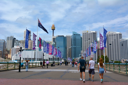 Sydney, Australia - OCT 20 2016:Visitors crossing the Pyrmont Bridge at sunset in Darling Harbour, a recreational and pedestrian precinct western to Sydney central business district in New South Wales, Australia.のeditorial素材