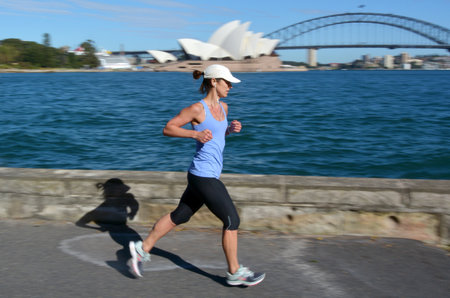 SYDNEY - OCT 19 2016:Australian woman runs along Sydney Harbour. Approximately 35% of the Australian population participated at least in one physical recreation activity.のeditorial素材