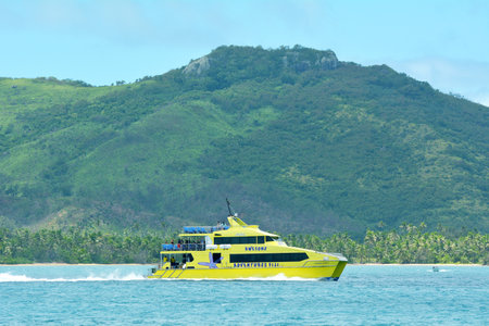 FIJI - DEC 20 2016: The bright yellow and fast catamaran, Yasawa Flyer, Fiji. It's a famouse high speed ferry transfers between the main island on Fiji and Yasawa & Mamanuca Island resorts.のeditorial素材
