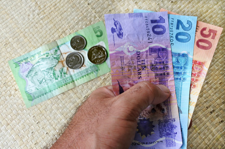 Tourist hand hold a Fijian money currency. Travel concept copy spaceの写真素材