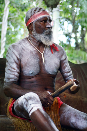 QUEENSLAND, AUS - APR 17 2016: Yirrganydji Aboriginal Australians man play Aboriginal music with Clapstick, percussion musical Instrument made out of wood in Queensland, Australia.のeditorial素材