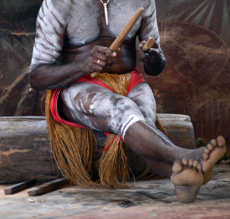 Yirrganydji Aboriginal man play Aboriginal music with Clapstick, percussion musical Instrument made out of wood in Queensland, Australia.の写真素材