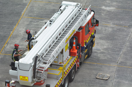 AUCKLAND - MAR 30 2017:Firefighters exercise on a fire engine ladder.Firefighter is a dangerous job...