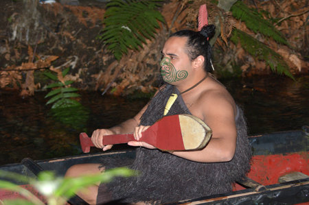 ROTORUA, NZL - APR 25 2017:Maori man in traditional waka boat.Maori are the indigenous people of New Zealand that migrated to New Zealand from Polynesia1000 years ago.のeditorial素材