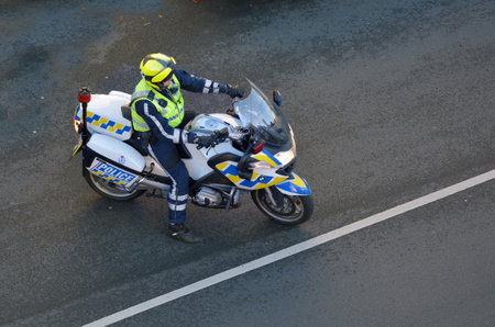 AUCKLAND, NEW ZEALAND - JUNE 08 2017: Police - Force Traffic Biker rides along the road and inspects...