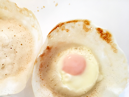 Hoppers with egg, a traditional Sri Lankan dish based on a fermented batter, usually made of rice...