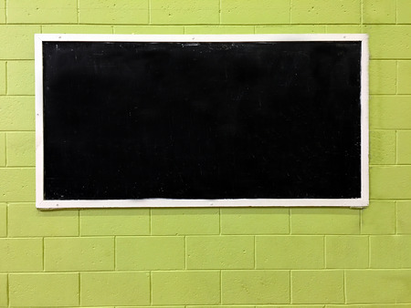 An empty blackboard on a brick wall ready for your text.の写真素材