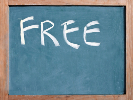 The word free written on a blackboard with space for your text.の写真素材