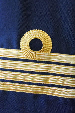 Navy uniform with captain rank on a sleeve. Abstract background and textureの写真素材