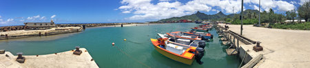 Panoramic landscape view of colourful fishing boats mooring in Avarua harbour in Rarotonga, Cook Islands.のeditorial素材