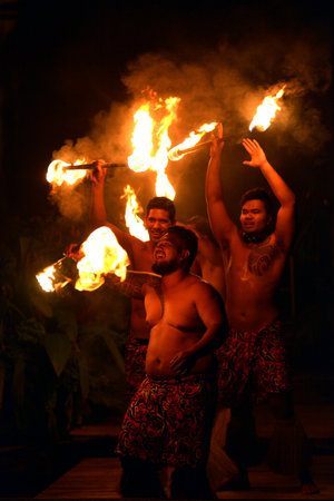RAROTONGA - JAN 07 2018:Cook Islander men fire dancing in Rarotonga Cook Islands.  The Fire Dance, regularly performed for tourists, have origins in the Pacific Islanders ancient rituals.のeditorial素材