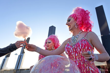Auckland, New Zealand -  Dec 02 2017: Drag queens sell cotton candy on the street of Auckland, New Zealad. Drag queen is a male who dresses in clothing of the opposite sex, acts with exaggerated femininity in feminine gender roles for entertainment or fasのeditorial素材