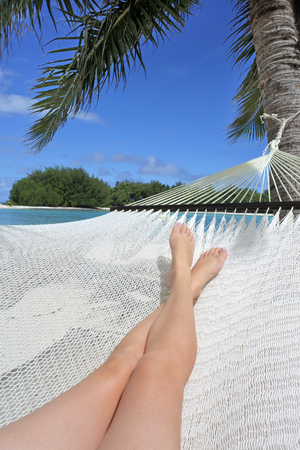 POV (Point of view) of a woman lay on a hammock relaxing in Muri lagoon in Rarotonga, Cook Islands. Real people. Copy spaceの写真素材