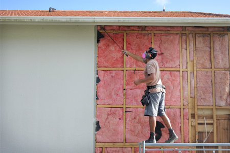AUCKLAND - APR 18 2018:Builder removing old fiberglass wall insulation.Home improvement companies traded asbestos insulation for fiberglass after finding out the harmful effects asbestos has on lungs.のeditorial素材