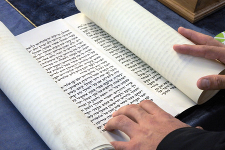 Jewish Rabbi reads The Megillah Scroll (Book of Esther) on Purim Jewish holiday.の写真素材
