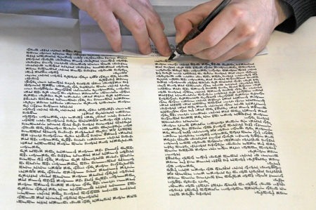 Sofer writing a sefer Torah in Hebrew. In the Torah's 613 commandments, the second to last is that...