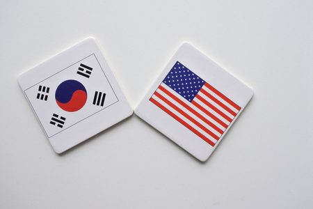 US and South Korea flags on white background. copy space