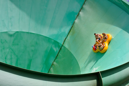 People ride on a water slide named Green Room in White Water World, Gold Coast, Australiaのeditorial素材