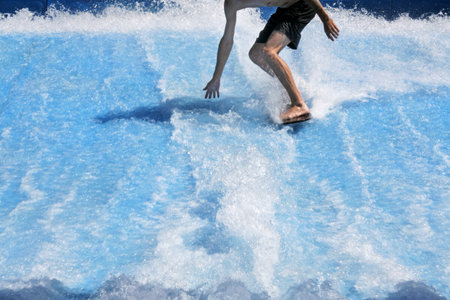 GOLD COAST, AUS -DEC 201 2018:Young man flowriding and flowboarding on artificial sheet waves. The...