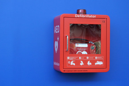 GOLD COAST, AUS - DEC 10 2018:Red Box Defibrillator Cabinet on a blue wall.Each year around 30,000...